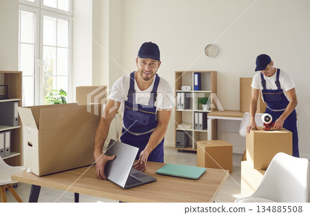 Young mover man packing laptop for moving, individual or company worker job moving office things Young mover man packing laptop for moving, individual or company worker job moving office things 134885508