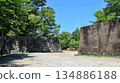 Wakayama Castle's stone walls stand out against the blue sky and fresh greenery 134886188