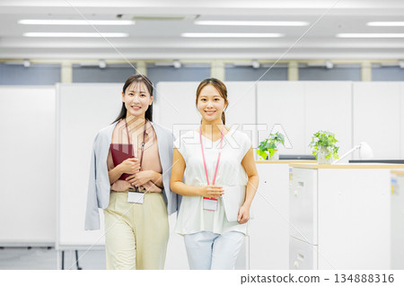 Women walking and talking in the office Women walking and talking in the office 134888316