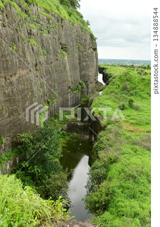 Walls and moats at Daulatabad Fort is an ancient fort located in Maharashtra, India. Originally named Deogiri,fort built from natural rocks and is very strong. it is a fort built from natural rocks. Walls and moats at Daulatabad Fort is an ancient fort located in Maharashtra, India. Originally named Deogiri,fort built from natural rocks and is very strong. it is a fort built from natural rocks. 134888544