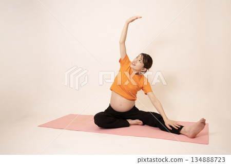 A woman doing maternity yoga A woman doing maternity yoga 134888723