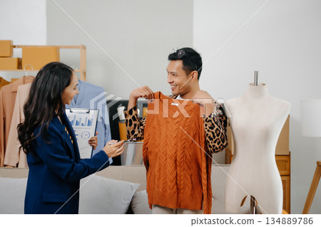 Two professional young Asia cheerful lady fashion designer teamwork with casual site on table use tablet meeting discuss final design share idea in shop. Two professional young Asia cheerful lady fashion designer teamwork with casual site on table use tablet meeting discuss final design share idea in shop. 134889786