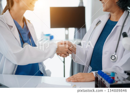 Doctor handshake and partnership in healthcare, medicine or trust for collaboration, unity or support.Team of medical experts shaking hands in teamwork for or success Doctor handshake and partnership in healthcare, medicine or trust for collaboration, unity or support.Team of medical experts shaking hands in teamwork for or success 134889846