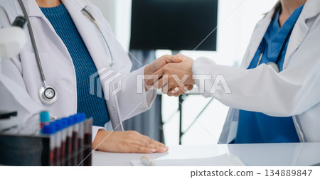 Doctor handshake and partnership in healthcare, medicine or trust for collaboration, unity or support.Team of medical experts shaking hands in teamwork for or success Doctor handshake and partnership in healthcare, medicine or trust for collaboration, unity or support.Team of medical experts shaking hands in teamwork for or success 134889847