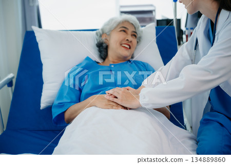 Caucasian doctor smiling take care of a young patient in hospital. Friendly nurse or therapeutic treat client Professional 134889860