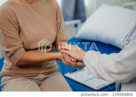 Asian female hands touching senior male hand Helping hands take care of the elderly concept in hospital 134889868