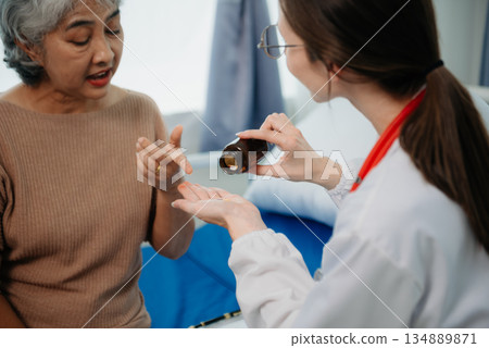 Asian female hands touching senior male hand Helping hands take care of the elderly concept in hospital Asian female hands touching senior male hand Helping hands take care of the elderly concept in hospital 134889871