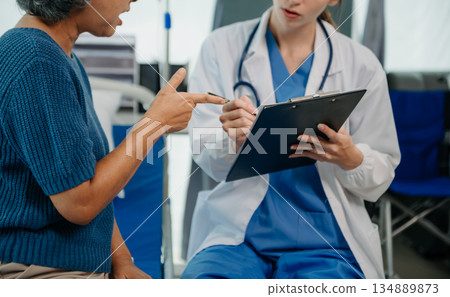 Asian female hands touching senior male hand Helping hands take care of the elderly concept in hospital 134889873