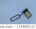 SIM card and pin on the SIM tray 134890131