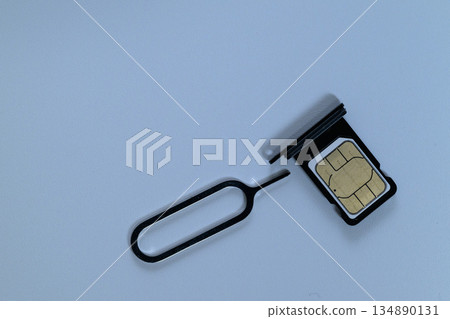 SIM card and pin on the SIM tray 134890131