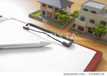 Image of comparing real estate properties and preparing documents 134890226