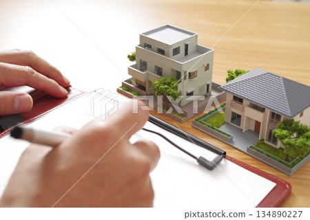 Image of comparing real estate properties and preparing documents Image of comparing real estate properties and preparing documents 134890227