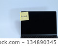 Password sticky note stuck on laptop screen 134890345