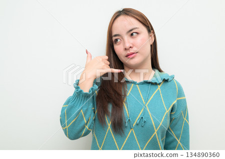 Portrait of a young Asian woman against white background 134890360