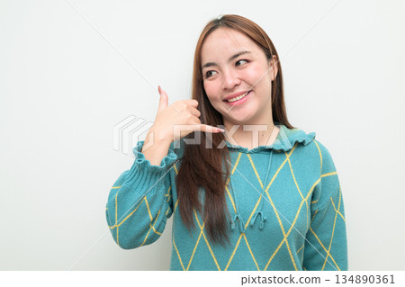 Portrait of a young Asian woman against white background Portrait of a young Asian woman against white background 134890361