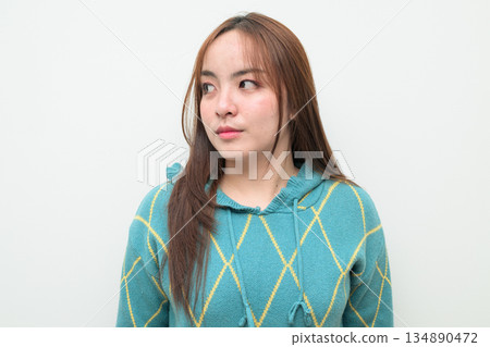 Portrait of a young Asian woman against white background Portrait of a young Asian woman against white background 134890472