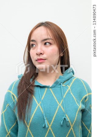 Portrait of a young Asian woman against white background Portrait of a young Asian woman against white background 134890473