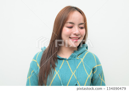 Portrait of a young Asian woman against white background Portrait of a young Asian woman against white background 134890479