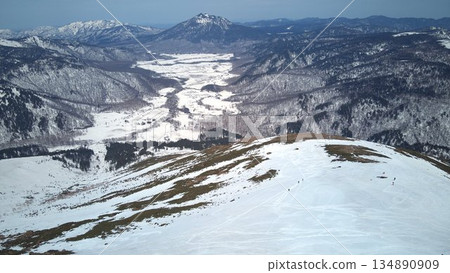 Aerial view of snow-covered Ozegahara and Mt. Shibutsu 134890909