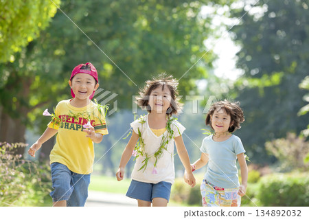 Three children playing in the park 134892032