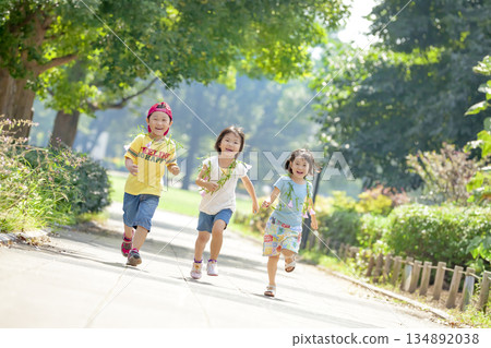 Three children playing in the park 134892038