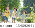 Three children playing in the park 134892041