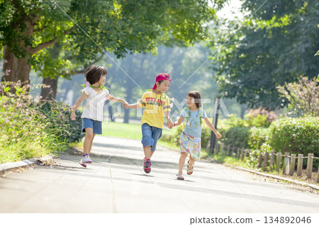 Three children playing in the park 134892046