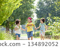 Three children playing in the park 134892052
