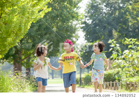Three children playing in the park 134892052