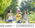 Three children playing in the park 134892053