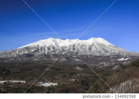 A view of Mount Ontake with snow remaining against the backdrop of a clear blue sky in early spring 134892398