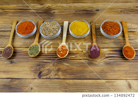 Set of different aromatic spices on wooden table Set of different aromatic spices on wooden table 134892472