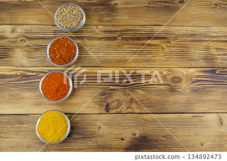 Set of different aromatic spices on wooden table. Top view, copy space Set of different aromatic spices on wooden table. Top view, copy space 134892473