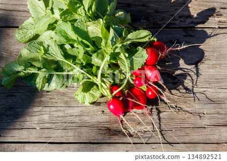 Fresh red radish with leaves on rustic wooden table. Top view 134892521
