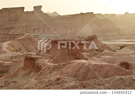 Kizil Red Stone Forest Scenic Area in Xinjiang , China is the strangely shaped red rock forests were carved by wind and sand over millions of years, giving them the appearance of abandoned cities. 134892912