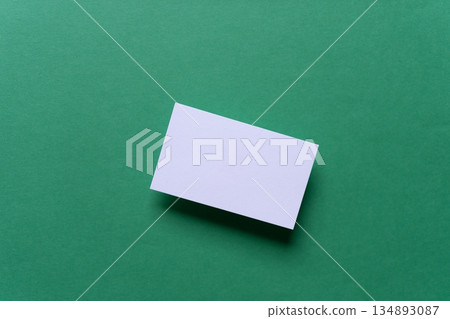 White card on a green background 134893087