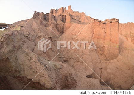 Kizil Red Stone Forest Scenic Area in Xinjiang , China is the strangely shaped red rock forests were carved by wind and sand over millions of years, giving them the appearance of abandoned cities. 134893156