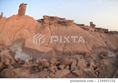 Kizil Red Stone Forest Scenic Area in Xinjiang , China is the strangely shaped red rock forests were carved by wind and sand over millions of years, giving them the appearance of abandoned cities. 134893158
