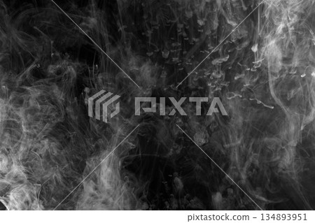 Abstract white smoke and fog drifting on dark black background with ample copy space, atmospheric texture for overlays and design Abstract white smoke and fog drifting on dark black background with ample copy space, atmospheric texture for overlays and design 134893951