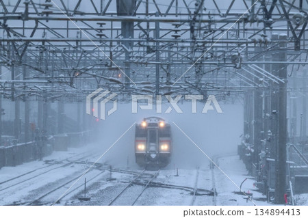 731 series train running through a snowstorm 731 series train running through a snowstorm 134894413