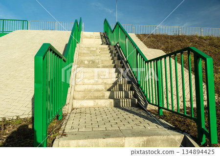 Concrete stairs with handrails leading up to the viaduct, Chelm, Poland 134894425