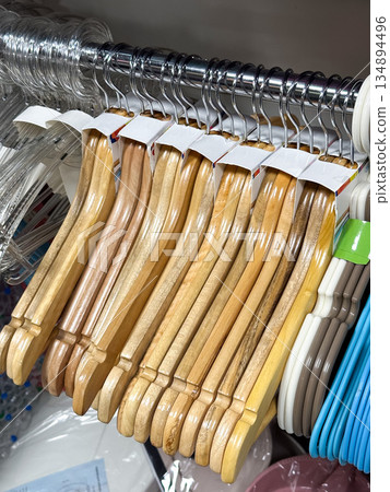 Wooden hangers on a rack for clothing organization. Wooden hangers on a rack for clothing organization. 134894496