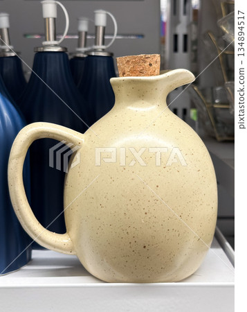 Ceramic jug with cork stopper in a store display. Ceramic jug with cork stopper in a store display. 134894517