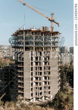 Construction of a building. Construction site with crane. Business, development, industry. 134894766