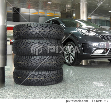 New vehicle tires stacked in the dealership showroom  134894967