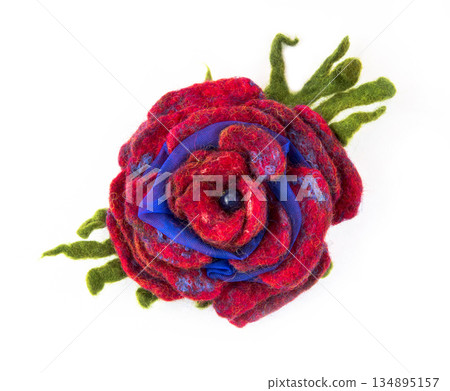 Brooch felted wool in the form of a flower on a white background Brooch felted wool in the form of a flower on a white background 134895157