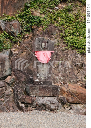 Ancient Stone Shrine With Vibrant Offering 134895424