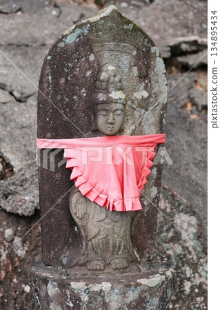 Ancient Stone Buddha With Red Ribbon 134895434