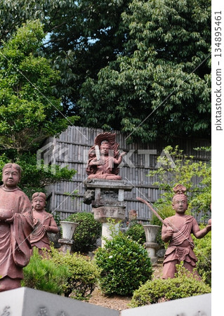 Guardian Statues Amidst Lush Green Foliage 134895461
