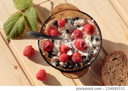 Cottage cheese with fresh raspberries and blueberries. Cottage cheese with fresh raspberries and blueberries. 134895531